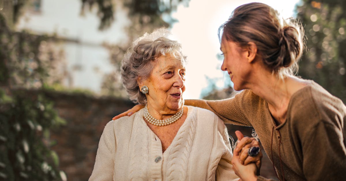 Elderly woman and adult daughter sitting together: how to convince elderly parents to move in with you